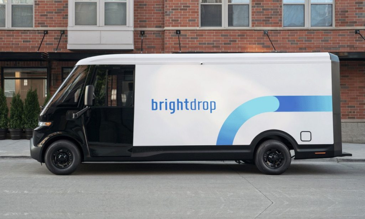 Side view of a GM BrightDrop EV Van parked outside a building.